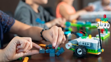 Children in the classroom collect figure from the designer