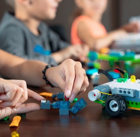 Children in the classroom collect figure from the designer