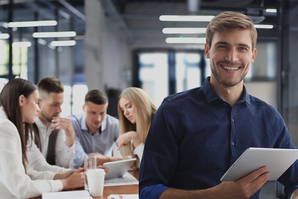 Businessman with colleagues in the background in office